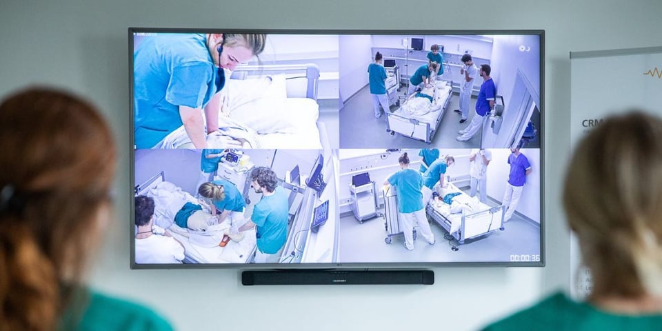 Split-screen view showing four camera perspectives during video debriefing.